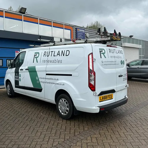 Silver van with graphics for an electrical company